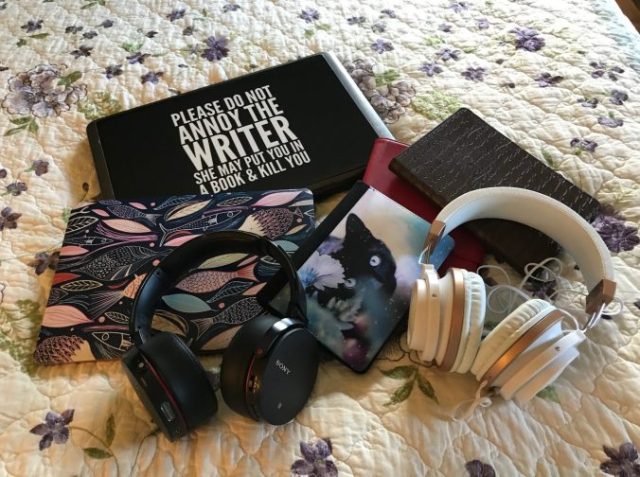 laptop, Mac book, Kindles and headphones